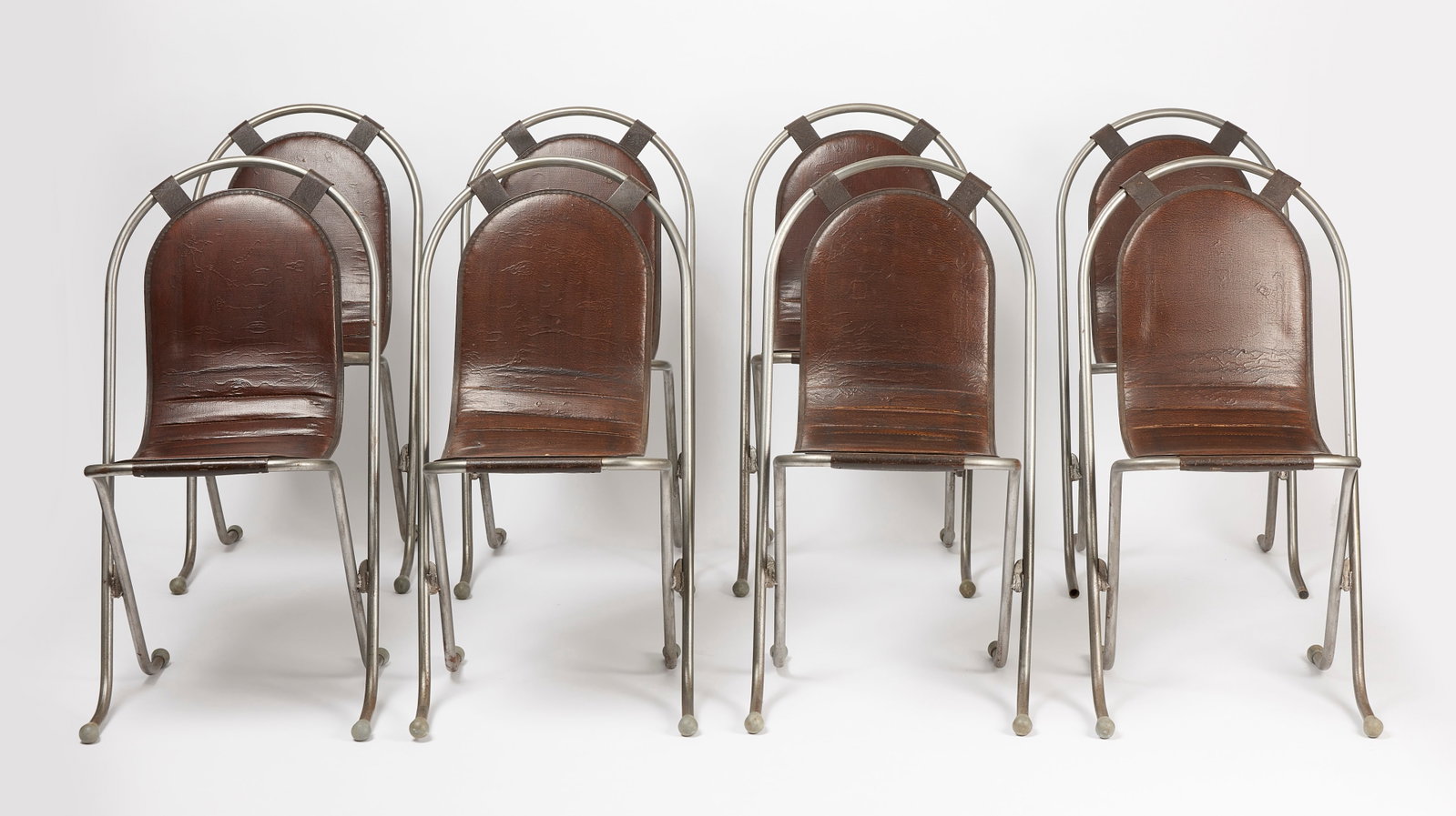 Eight Harry Sebel Stak-A-Bye Chairs with Original Naugahyde Seats: Harry Sebel. Eight steel Stak-A-Bye chairs with original naugahyde seats. English, circa 1950. H 33-3/4" D 19-1/4" W 17-3/4" SH 18" Link to Elemental 