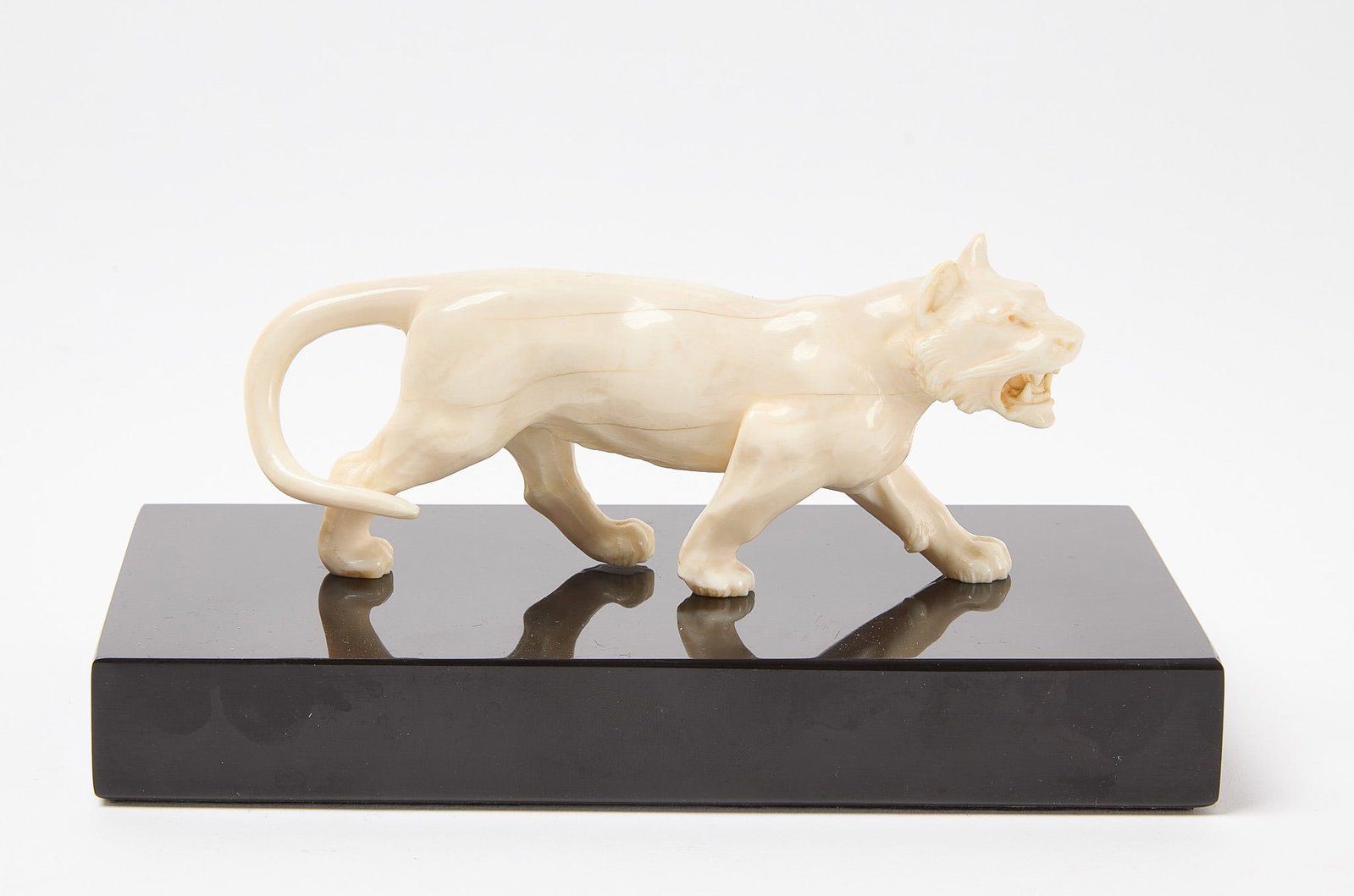 Bone Tiger with Onyx Base: Tiger sculpture. Carved bone with onyx base. Tiger: L 6" Overall: L 7-1/2" Condition: Excellent. 