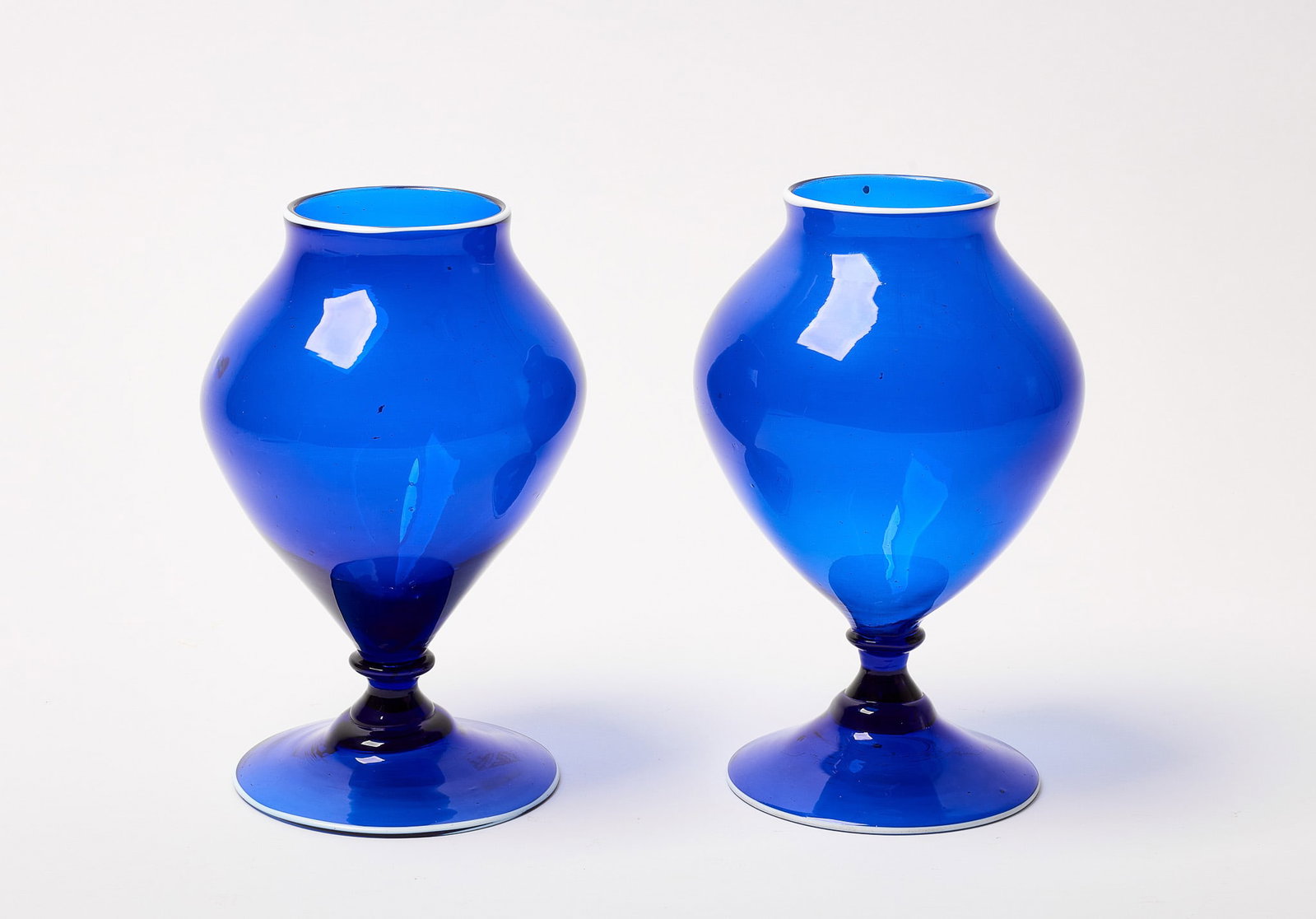 Pair of Cobalt Blue Blown Footed Vases: Pair of cobalt blue footed vases. Blown glass. H 8-1/2" D 5-1/4" Condition: Excellent.