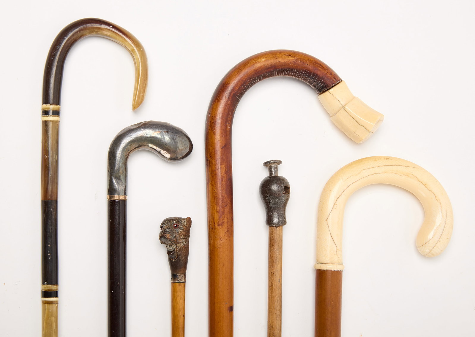 Six Vintage Walking Sticks: Six vintage walking sticks. One features a bulldog head with hinged mouth. Others may feature sterling or bone additions. H 25" to H 35-3/4" Condition: Good with minor imperfections.&nb