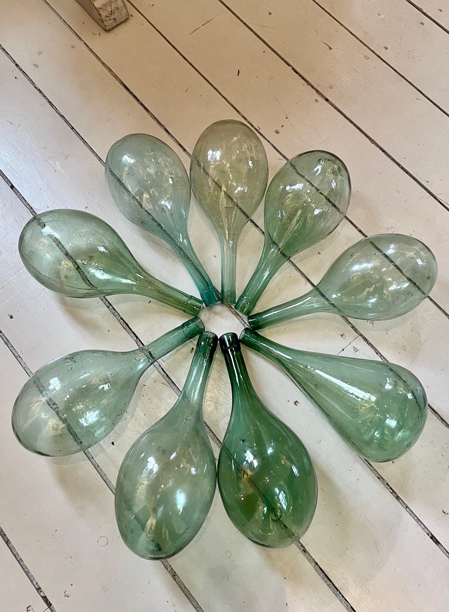 Nine Quarterjohn Bottles: Nine quarterjohn bottles. French, circa 1880-1930. H 13-3/4" D 5-1/2" Condition: Excellent with minor imperfections. Link to Elemental Garden webpage for additional information: https://www.theelement
