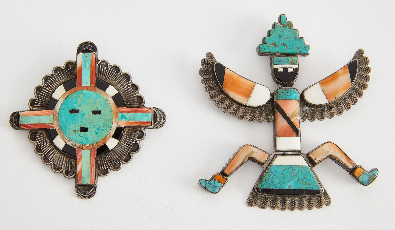 Two Zuni Pins: Two vintage Zuni pins with inlay work. Knife Wing: H 3-1/4" W 2-3/4". Sun: H 2-1/2". Condition: Excellent condition with no damage noted. Copy and paste link for high-res images: h