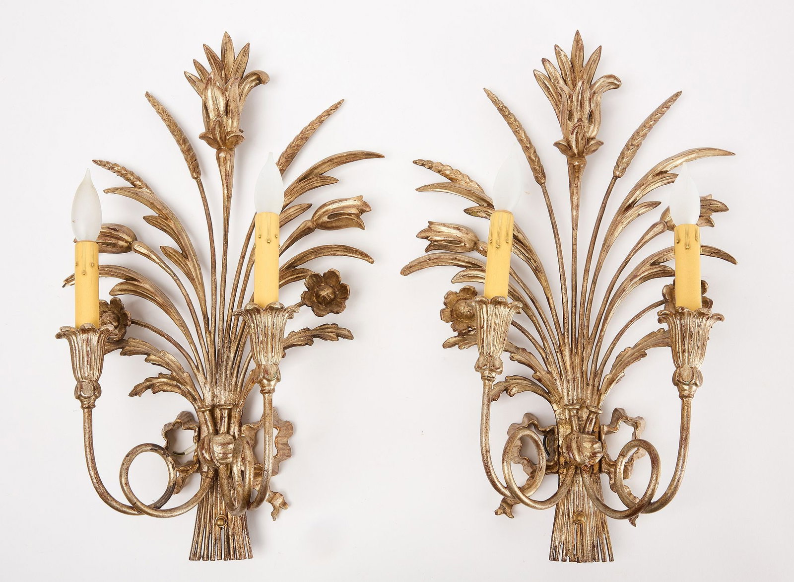 Pair of Wall Sconces: Pair of wall sconces with wheat and floral design. Metal with carved wood, gesso and gilding. Electrified. 20th century. H 23" W 14-2/3" D 5-3/4". Condition: Minor imperfections. 