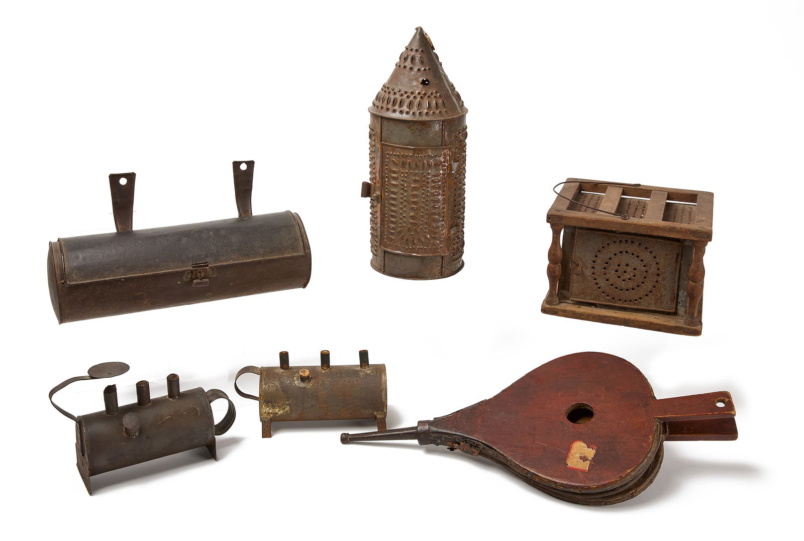Fireplace Lighting Lot: Early fireplace and lighting lot. Includes early bellows in original paint and leather, a turned wood and tin foot warmer (dated), a pierced tin lantern, hanging candle box and two tin pig lamps.