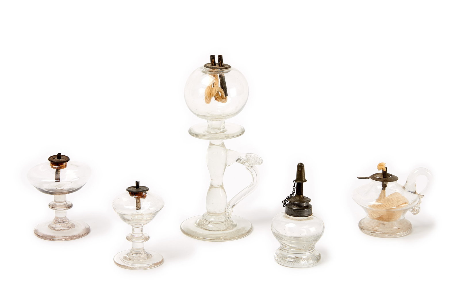 Five Whale Oil Lamps: Five blown glass whale oil lamps. Four small lamps and one larger. Larger lamp is a Sparking Lights and Lacemaker's Lamp. New England, early to mid-19th century. Provenance: Marvi