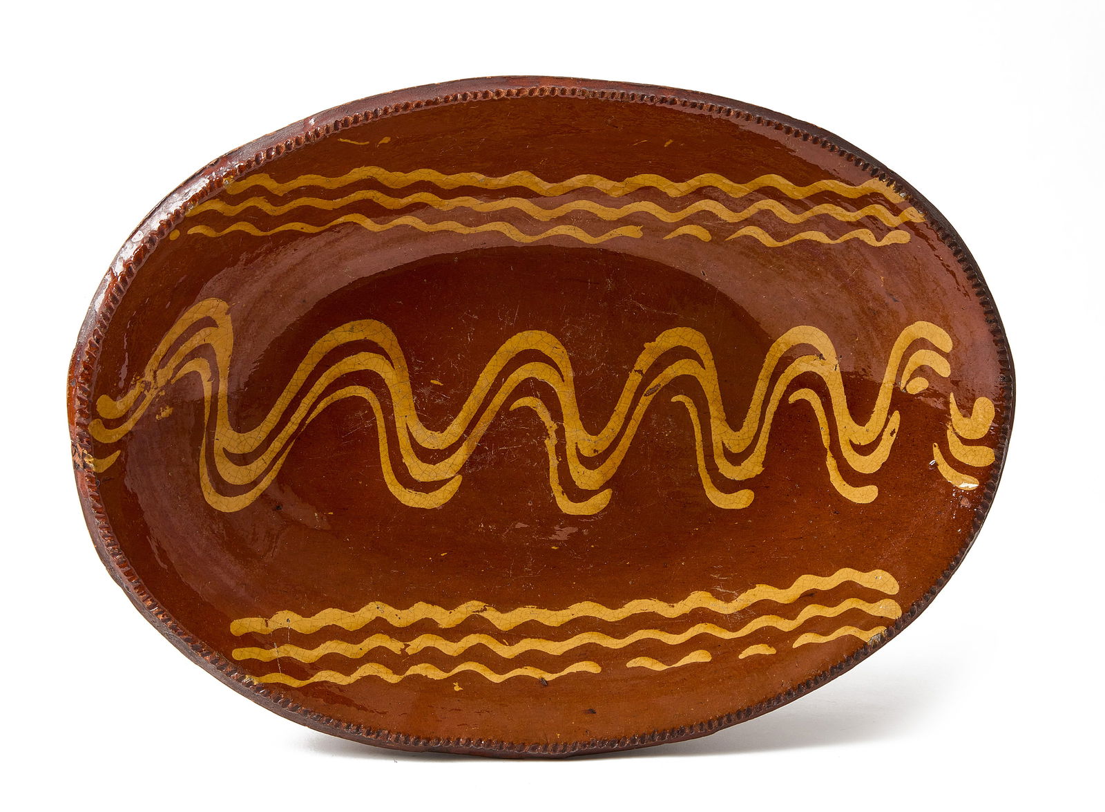 Redware Loaf Dish: Redware loaf dish with slip decoration. Northeastern United States, probably Norwalk, Connecticut, circa 1830. Provenance: Axtell Antiques. H 3" L 12" W 16-1/2". Condition: E