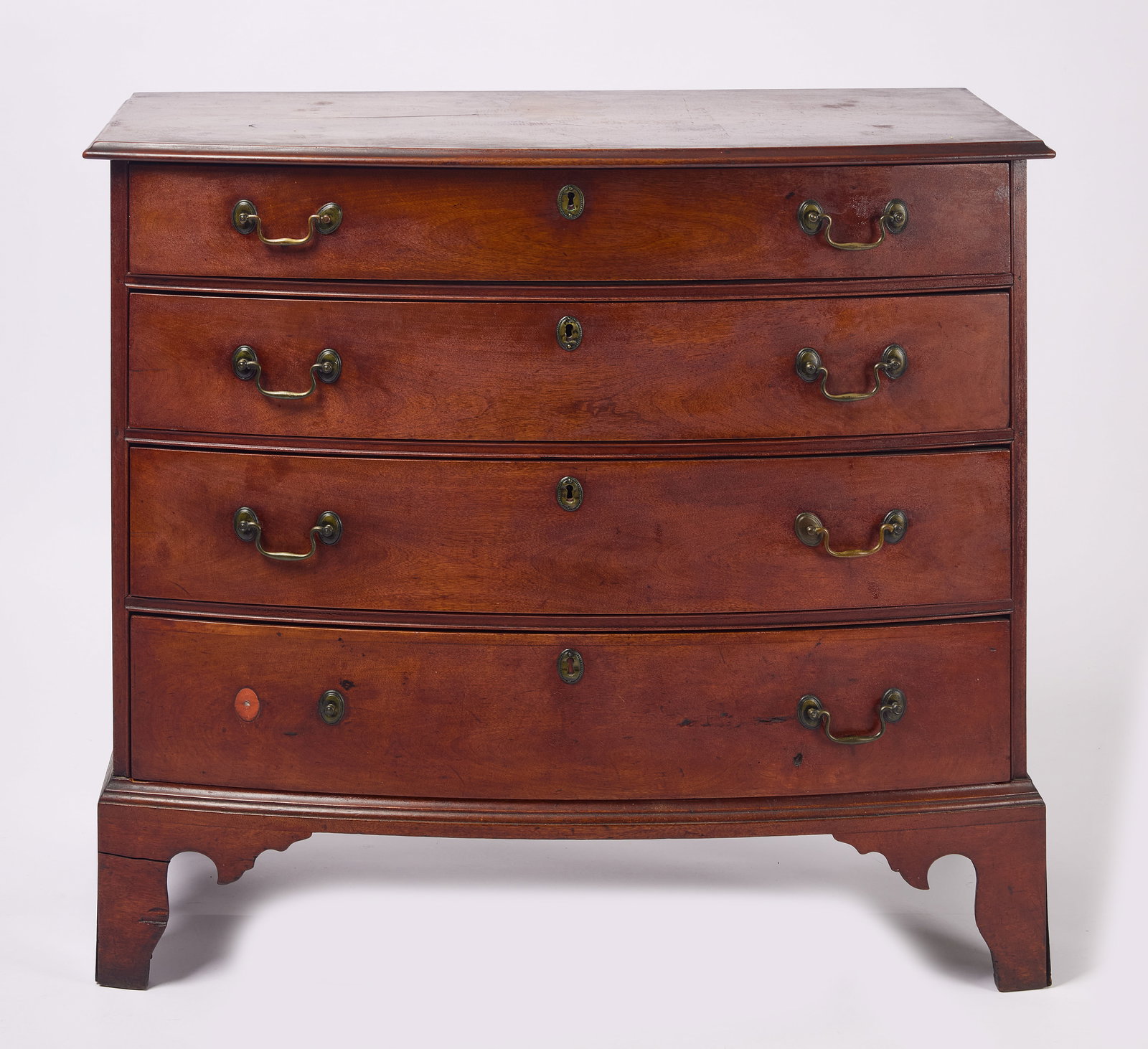 Bow Front Chest: Bow front chest with molded top, bracket feet and early. possibly original brasses. Birch wood with original finish. New England, circa 1800. H 35-1/2" W 38-1/2" D 18". Condition: Excel