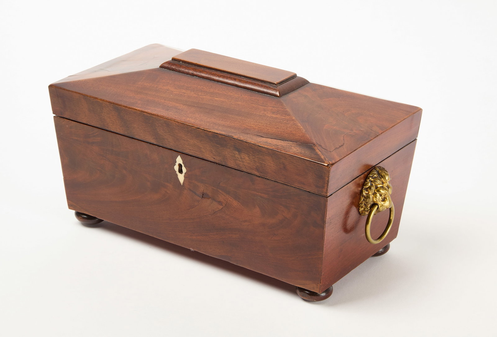 Tea Caddy: Tea caddy. Brass lion head handle mounts and bone inlay around keyhole. Etched glass cup inside. H 7" W 12-1/2" D 6-1/2". Condition: Minor surface imperfections. No damage noted. Hairli