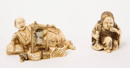 Two Carved Bone Smiling Figures