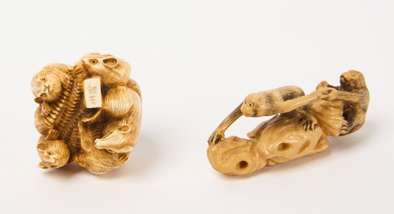 Two Netsuke with Animals: Two netsuke with animals. The first depicts two monkeys, one guiding the other. Signed. The second depicts seven mice. Carved bone. 19th to early 20th century. Monkeys: H 1" L 2-1/