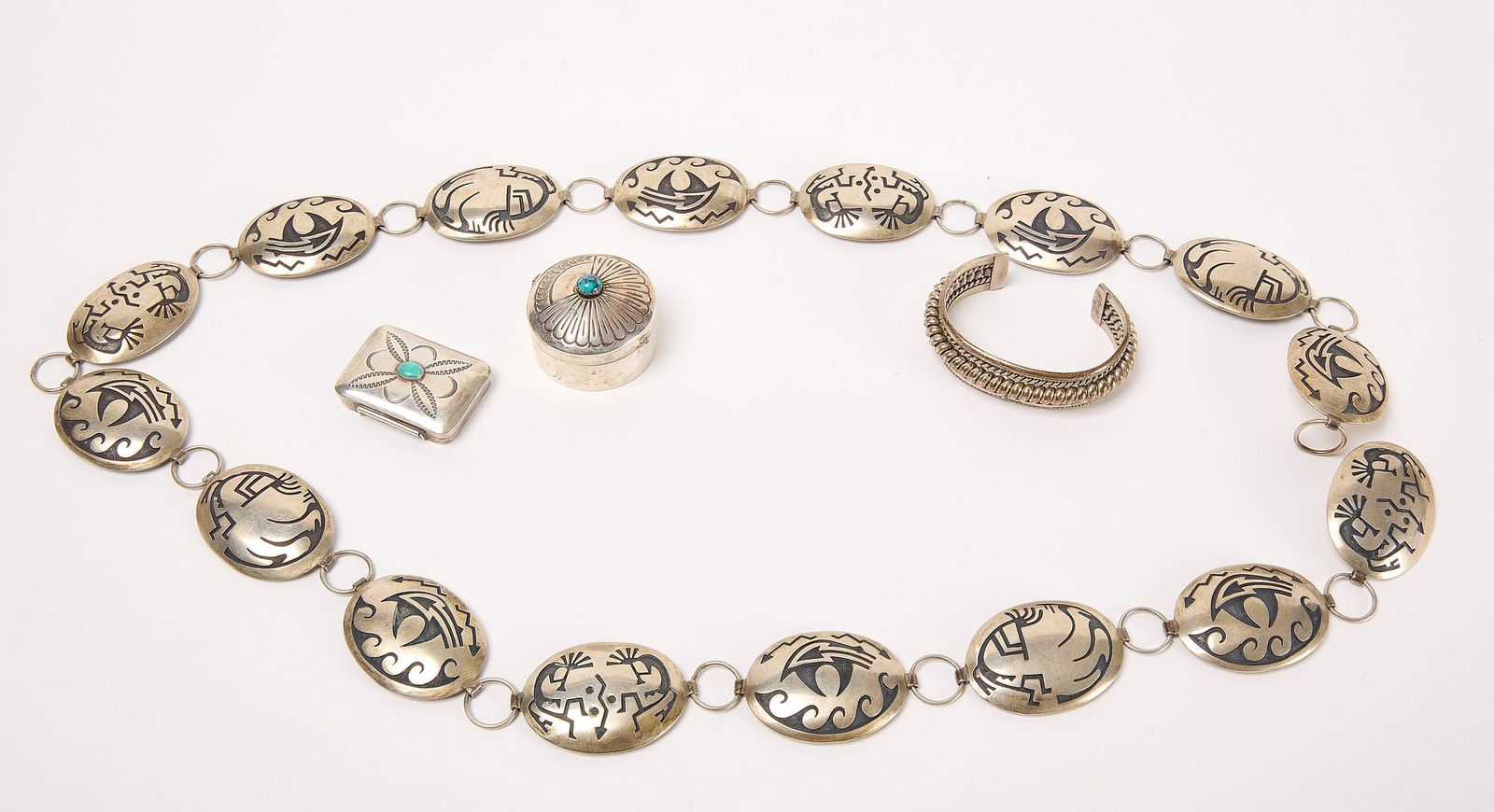 Group of Native Silver: Group of Native American silver. Including a belt, two small pill boxes with turquoise and a cuff bracelet. Round box and belt are signed. 13.65 ozt. Belt: L 43" Cuff bracelet: H 2" W 3