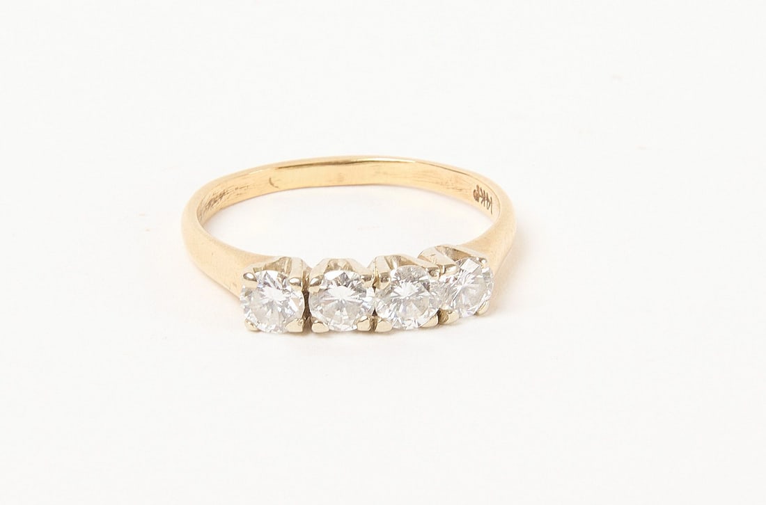 14k Diamond Ring: 14k diamond ring with four 20 pt diamonds. Size 6.5. 1.5 dwt. Condition: excellent with two very small girdle chips 