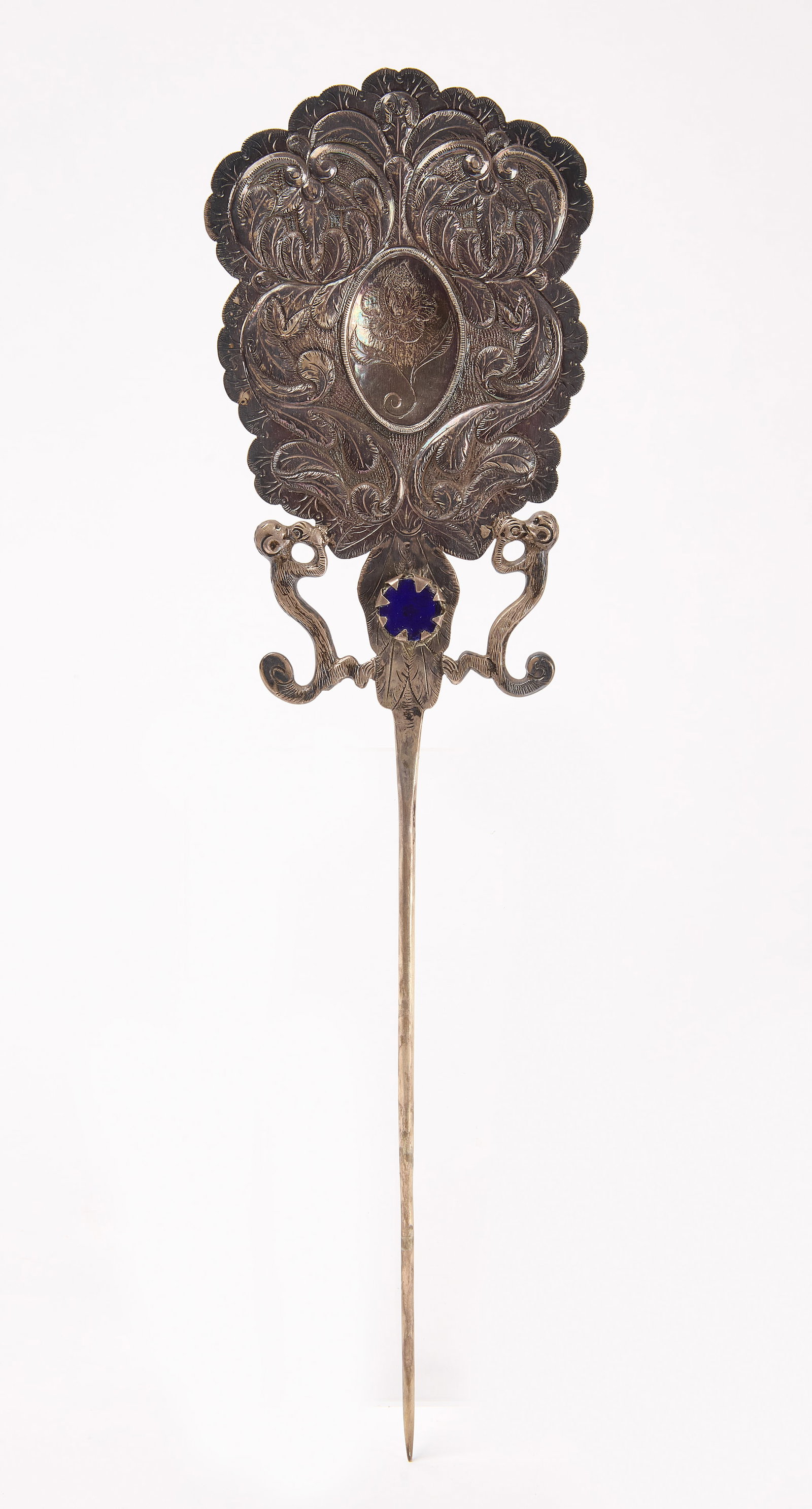 Peruvian Silver Shawl Pin: Peruvian silver shawl pin. Tooled silver with single glass bead. Possibly a low-grade silver, or heavy plating. South American, early 20th century. L 14-1/2" W 4". Condition: Minor surface t