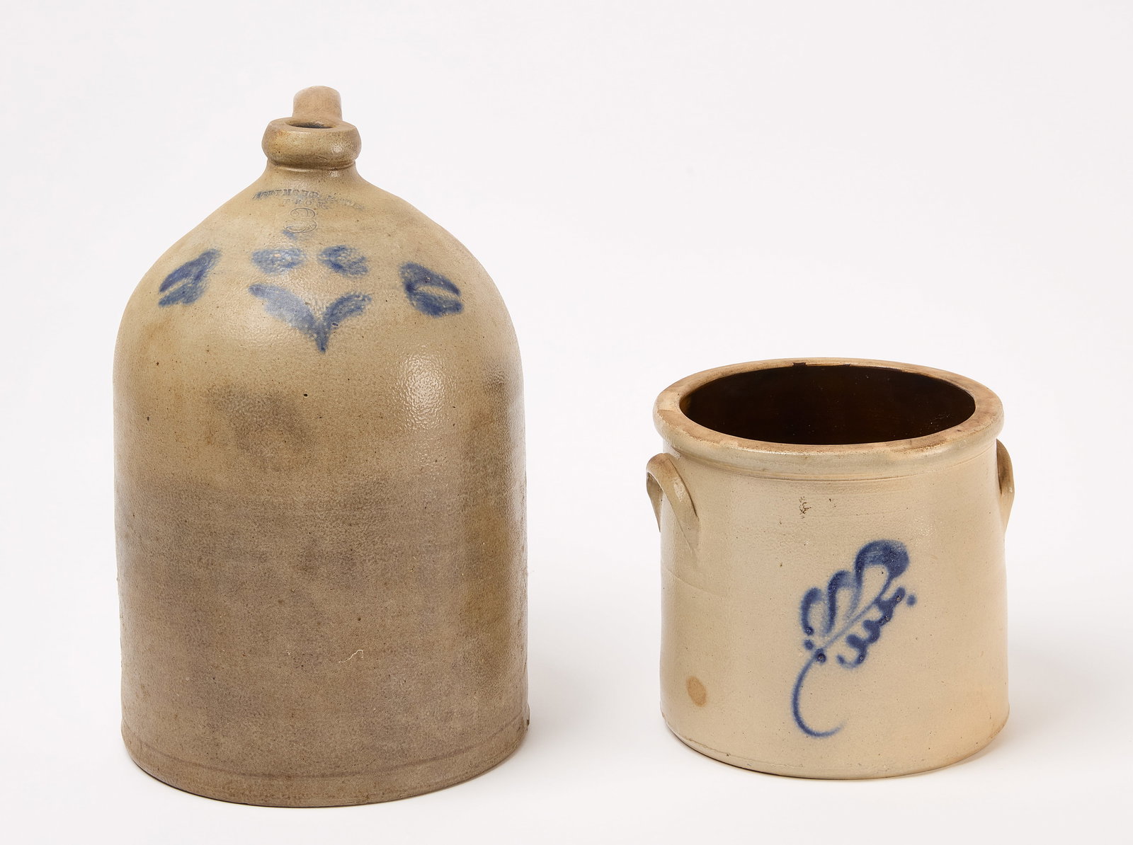 Stoneware Jug and Crock: Stoneware 3-gal jug by Seymour & Sons, Troy, NY. Together with a stoneware crock with cobalt blue decoration. Jug: H 14-1/2" D 9-1/2". Crock: H 7-1/2" D 8-1/4". Condition: Very