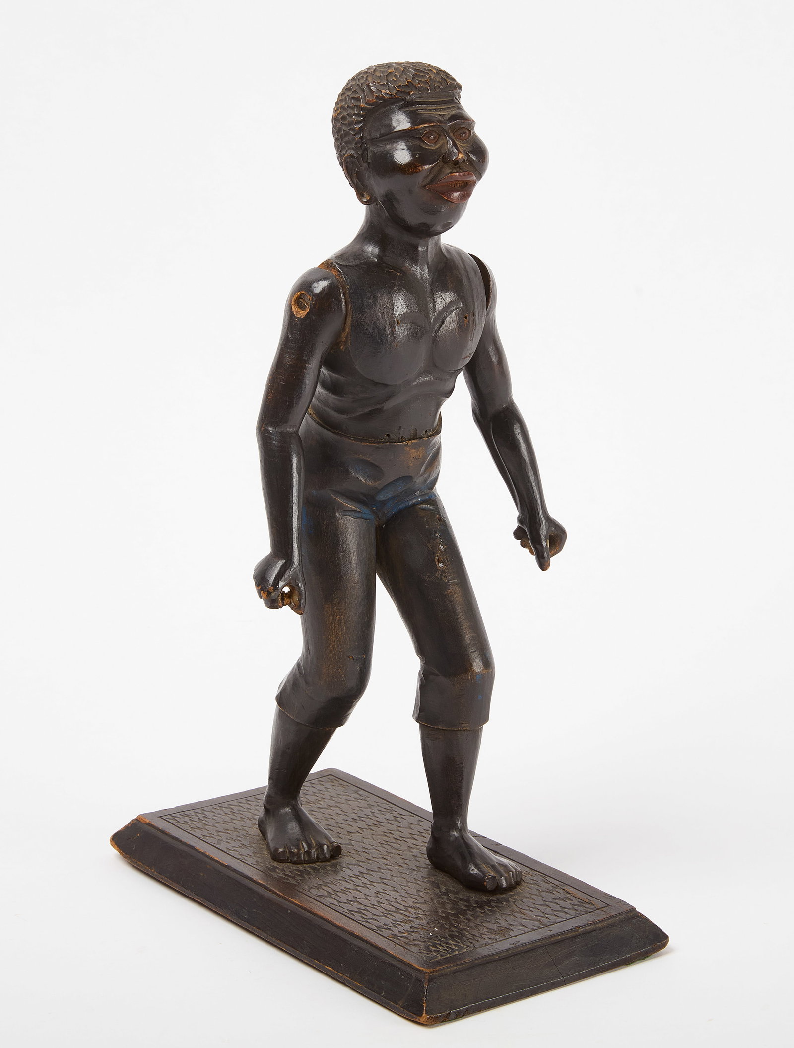 Figure of a Black Man: Figure of a Black man. Carved wood with original paint. American. Second half of 19th century. H 14-3/8" W 5-1/4" D 9-1/2". Condition: Minor surface imperfections. Once held somet