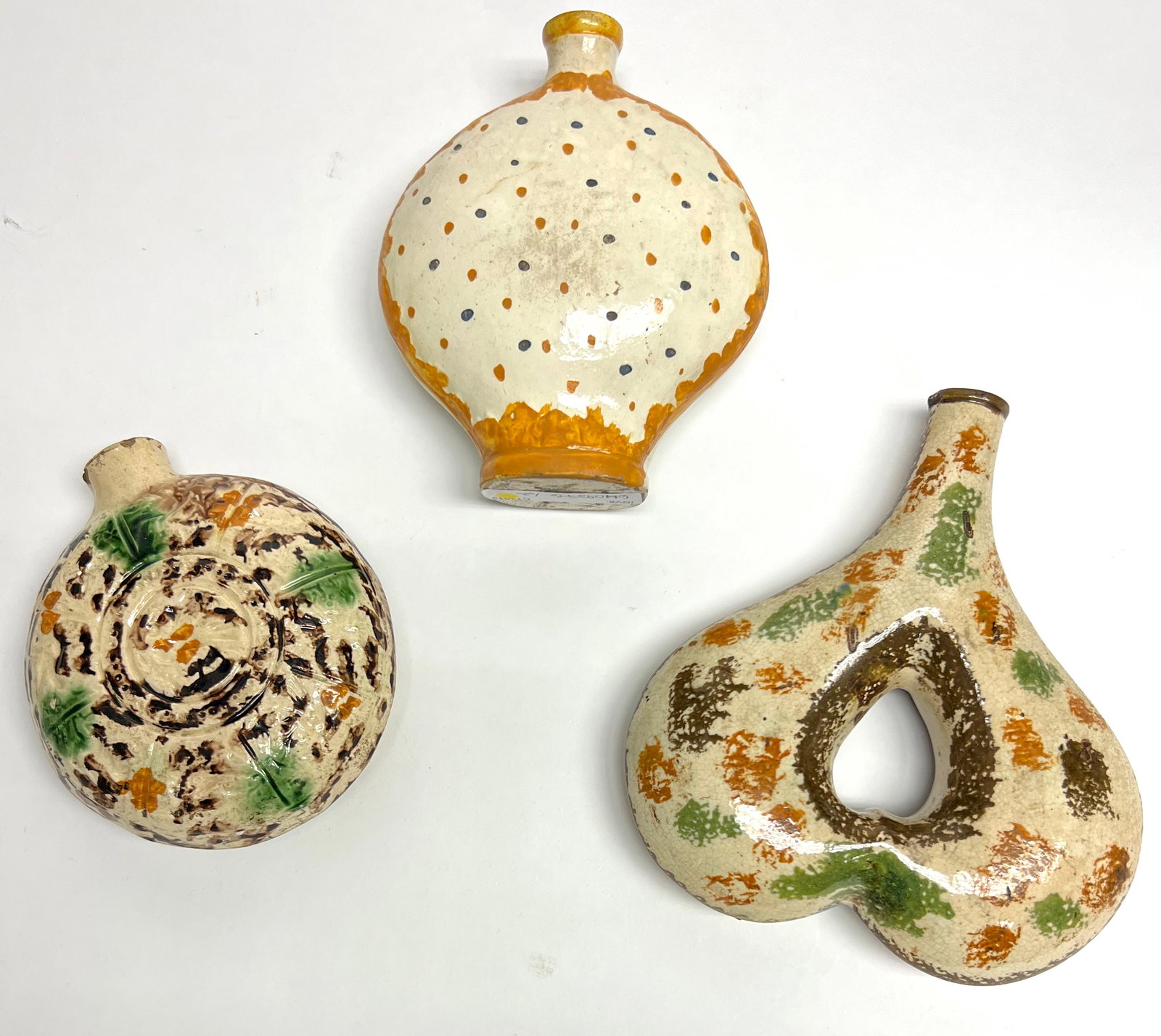 Three English Ceramic Flasks: Three ceramic flasks. English, circa 1800. H 4-1/2" Dia. 4". H 5-1/4" W 4-1/2". H 6-1/2" W 5-3/4". Condition: No damage noted. Link to hi-res images: https://www.dro