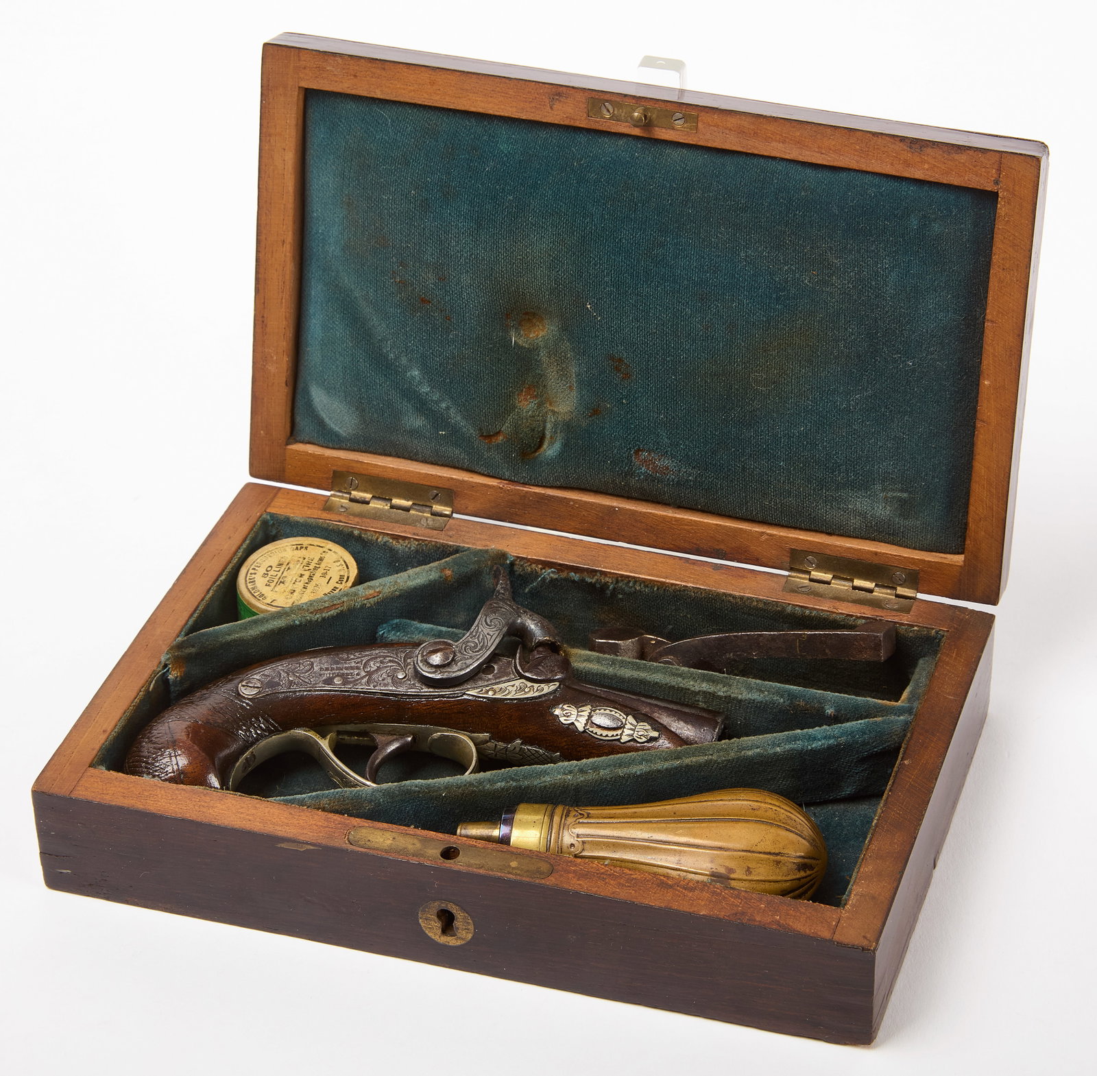 Henry Deringer – Pocket Pistol: Henry Deringer (1786–1868). A .44 caliber-pistol. Walnut stock, damascus barrel, finely engraved silver furniture, silver butt plate. Complete with original case, lead ball tool, and brass shot 