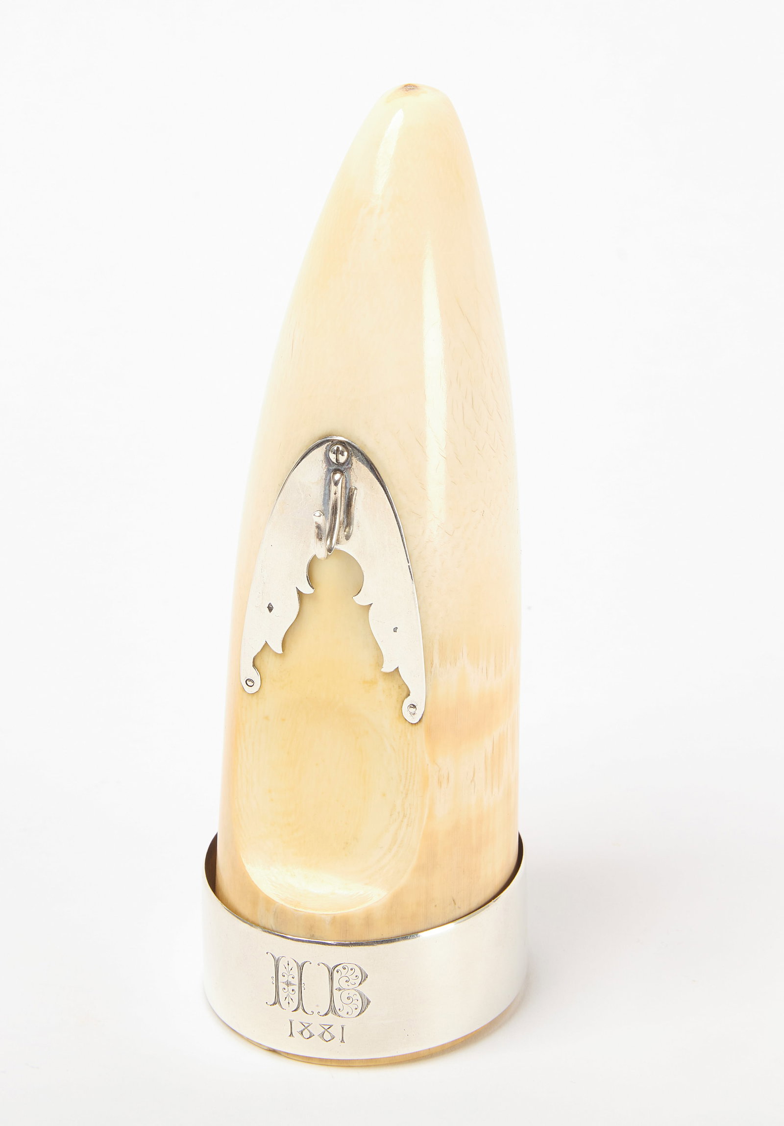 Carved Tusk Watch Holder: Carved tusk or bone with silver hardware to hold keys and or a pocket watch. Band inscribed with initials 'HB' and date '1881'. American. H 7" W 2-1/8" D 2-3/4". Conditi