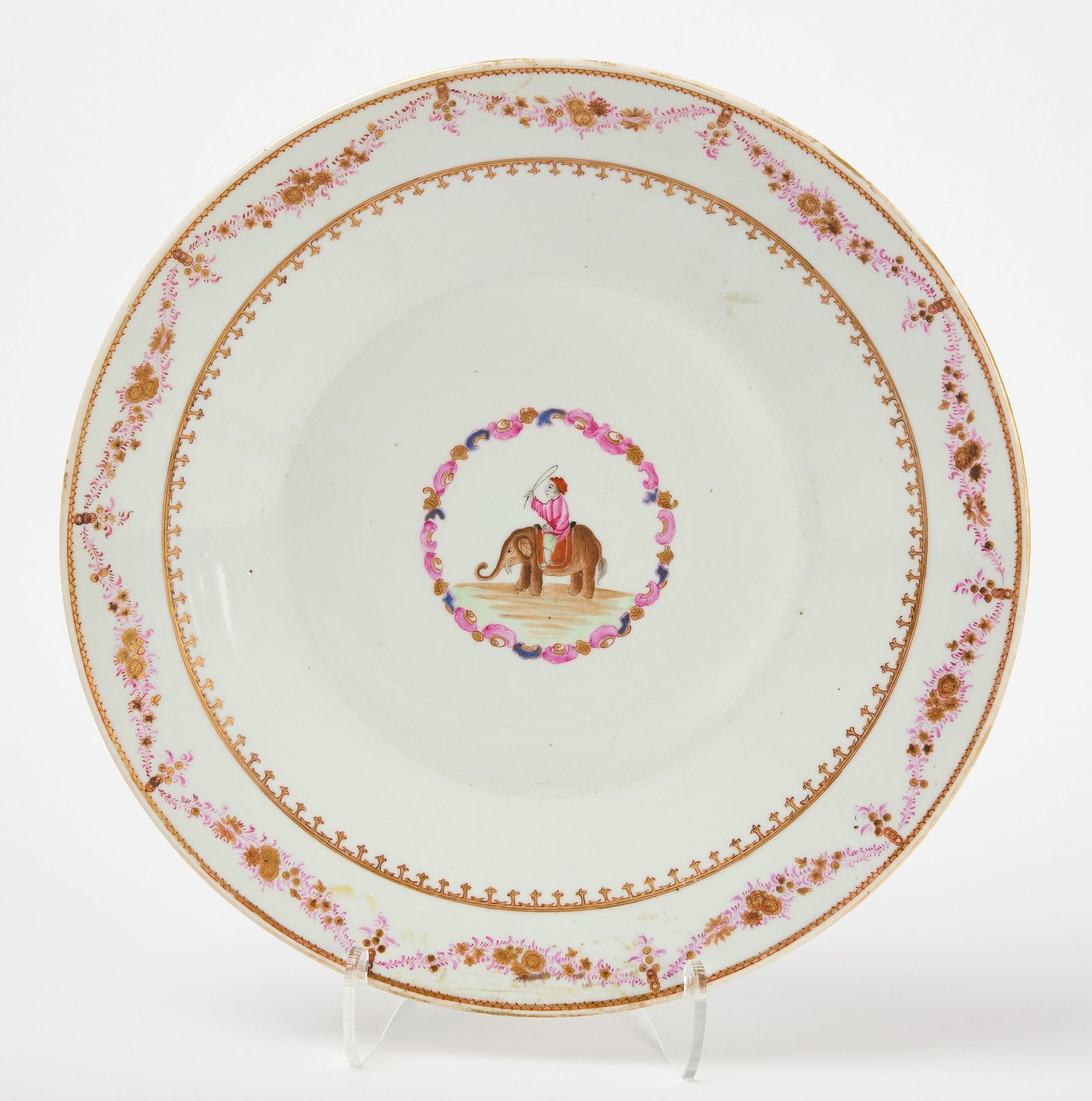 Export Charger with Elephant: Export charger with elephant and rider in central medallion. Rim with floral swags and two border trimmings. Circa 1800. H 2-1/4" D 14-1/2". Condition: Old sticker residue on underside. No damage note