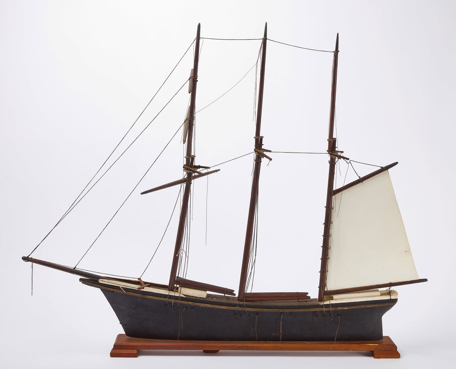 Schooner Weathervane: Schooner weathervane. Carved and painted wood, metal sail and oiled twine rigging. Coastal New England, circa 1920. H 37 in. W 45 in. Condition: Minor imperfections. Hull is in origin