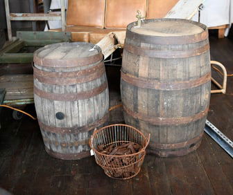 Two Vintage Whiskey Barrels with Industrial Basket of Railroad Spikes