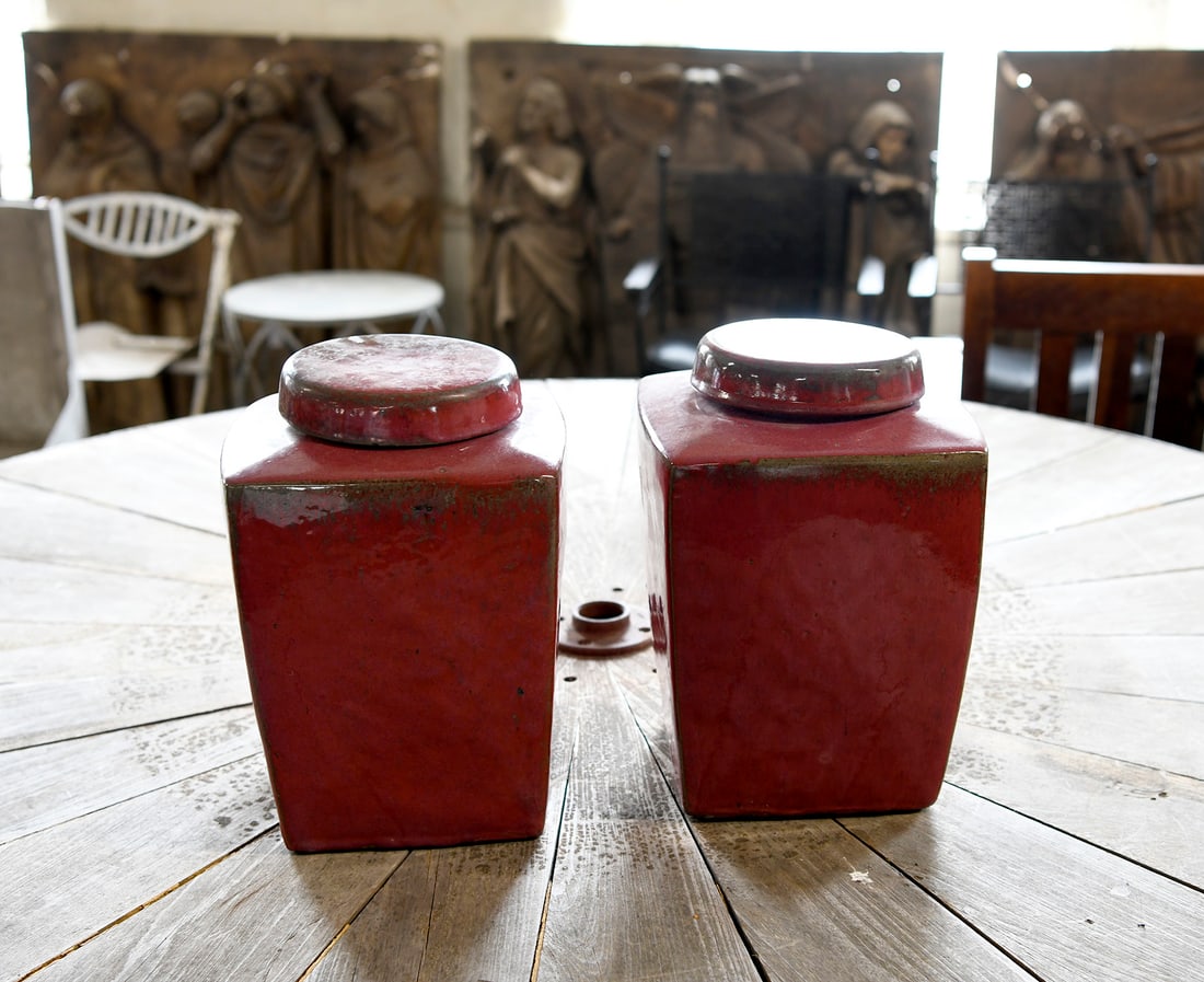 Pair of Lidded Stoneware Vases: Pair of lidded stoneware vases. Burgundy glaze. H 14-1/2" W 10" D 10".