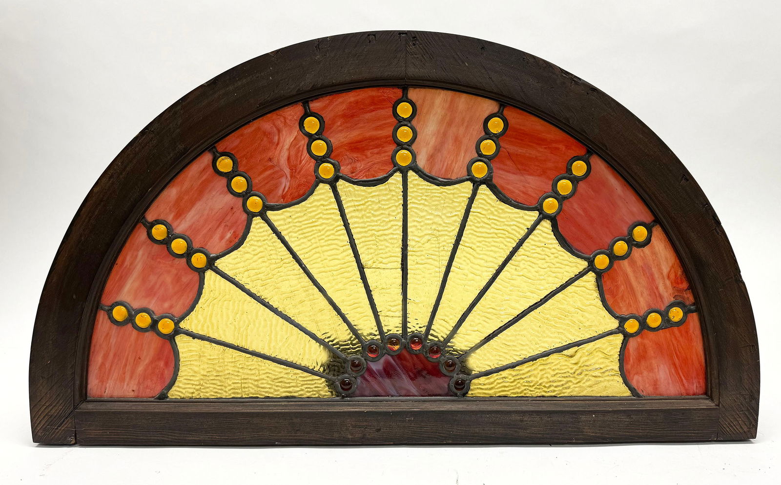 Demilune Stained Glass Window: Demi-lune shaped stained glass window. Nearly resembles a spiderweb. 19th century. Frame: H 19-1/8 in.W 34 in. Window: H 15 in. W 28-1/2 in. Condition: A few hairline cracks in glass. Piece is stable.