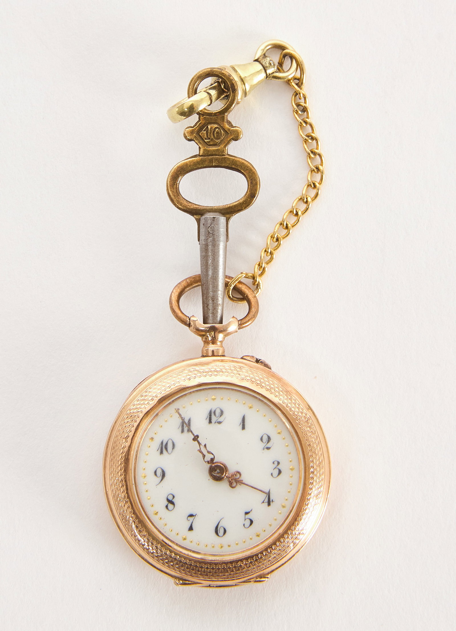 14k Gold Key-Wind Pocket Watch: An early pocket watch in 14k gold case. Stamped '585' inside case, clip appears to be gold filled. Porcelain dial under beveled glass. Circa 1875. Overall: D 1-1/4 in. Dial: D 1 in. Overall We