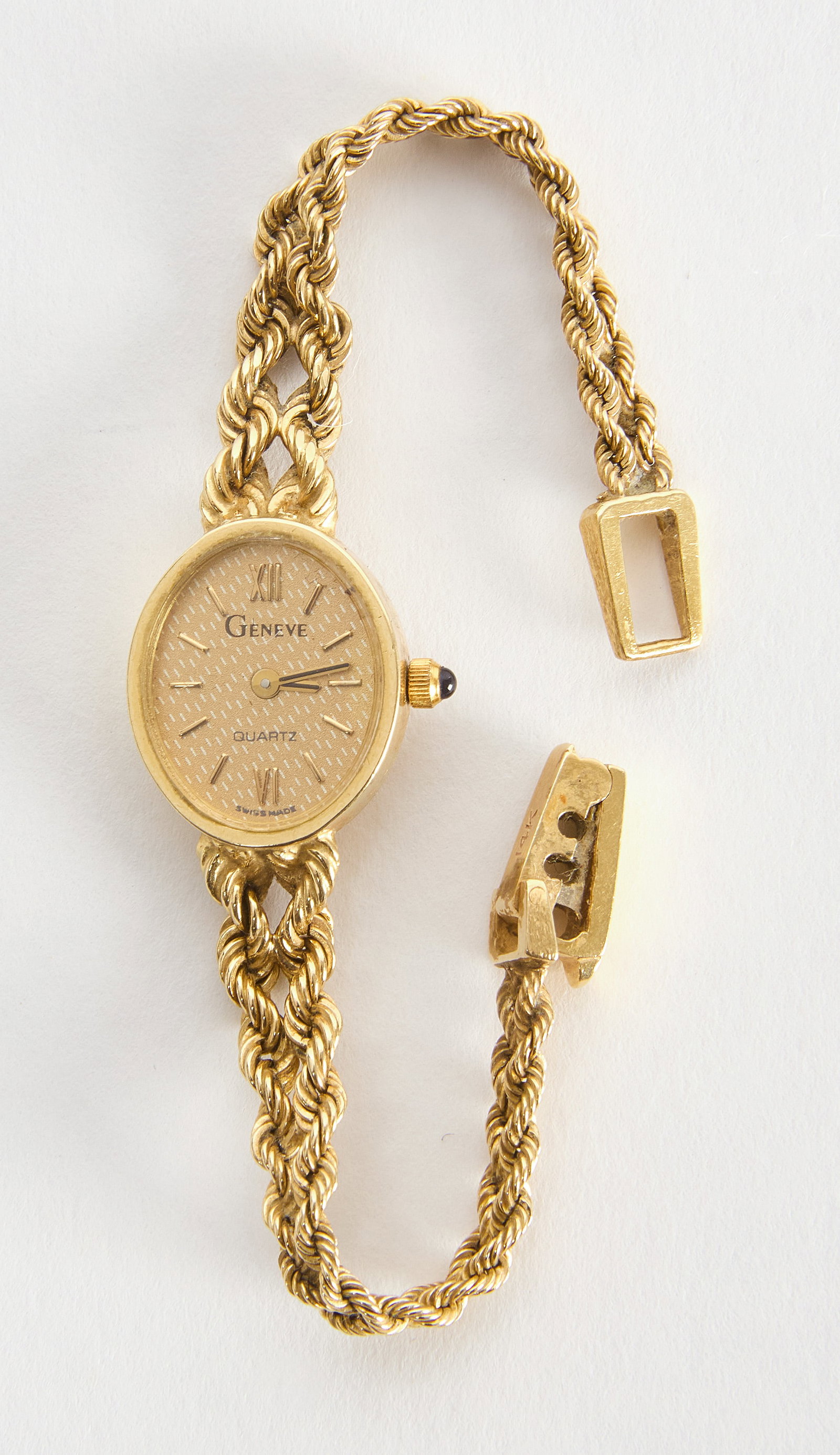 Geneve 14k Gold Ladies Watch: Geneve 14k gold ladies watch. A dainty ladies watch with an oval face. Woven strap. Stamped 14k on the back of the watch face and on watch clasp. Front watch-face says 'Geneve', 'Quartz