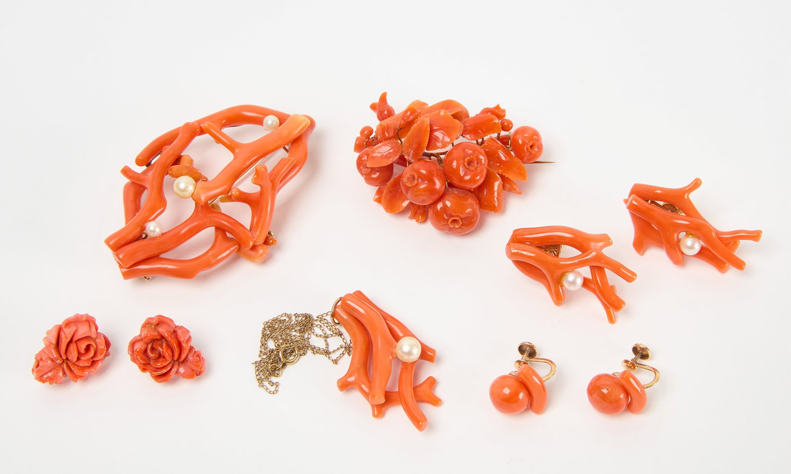 Group of Coral Jewelry with Pearl Accents: Group of coral jewelry with pearl accents. Necklace, 3 pairs of clip on earrings and two pins. Necklace L: 11-1/2 in. Largest clip-ons: H 1-3/8 in. W 3/4 in. Condition: Clasps all in