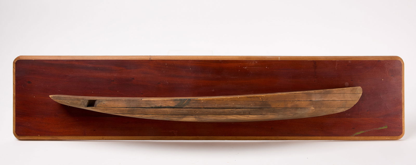 Half Hull Model: Half hull ship model. American, mid 20th century. Board: L 49-1/2" W 10-1/2" Model only: L 38-5/8" W 2-3/4". Condition: Excellent original condition with minor imperfections. Link