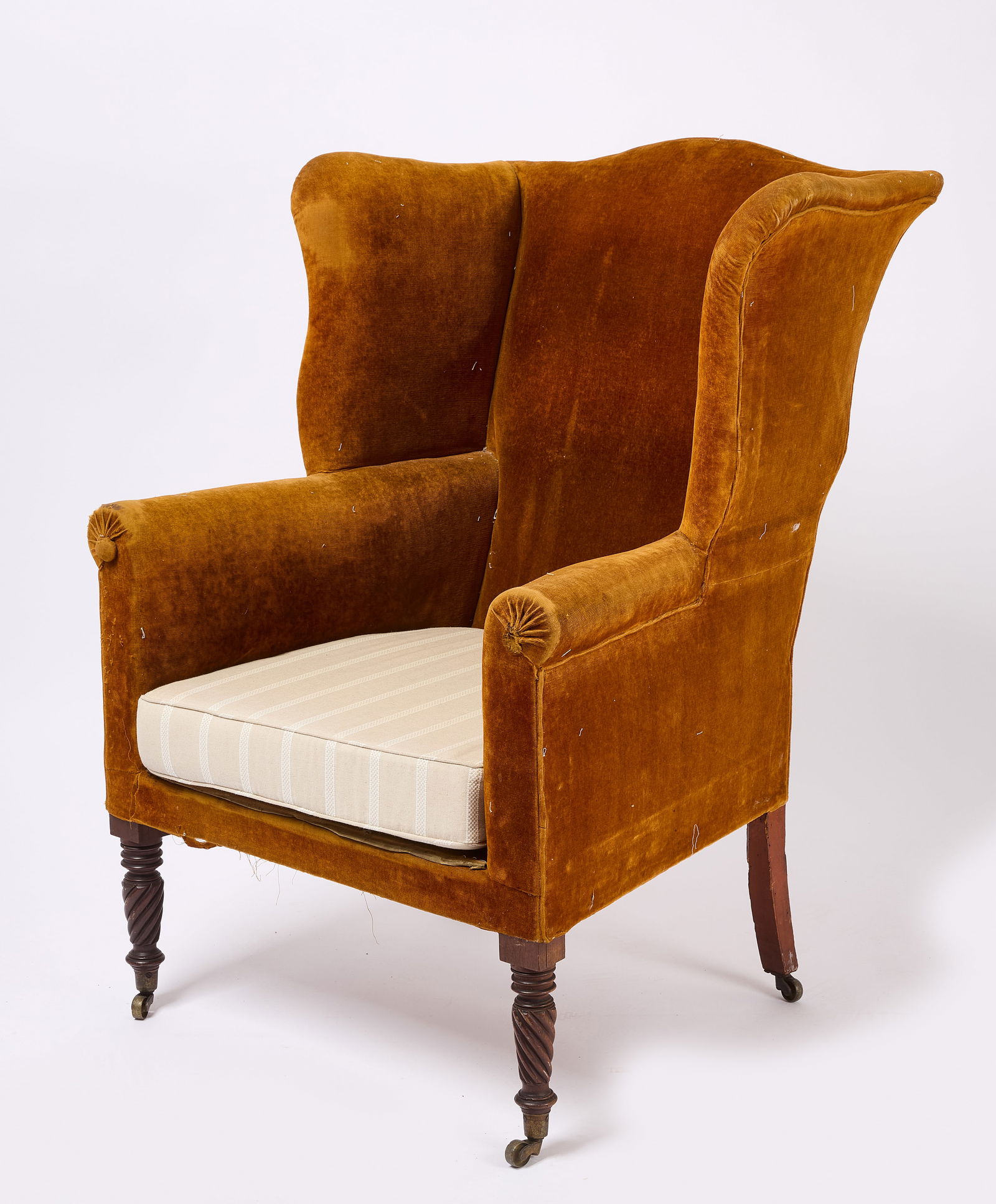 Wing Chair: Sheridan wing chair with tan and white striped upholstery. Turned front legs on castor wheels. American, circa 1825. H 44-1/2" W 33" D 24-1/2". Condition: Overall good. Link to hi-res i