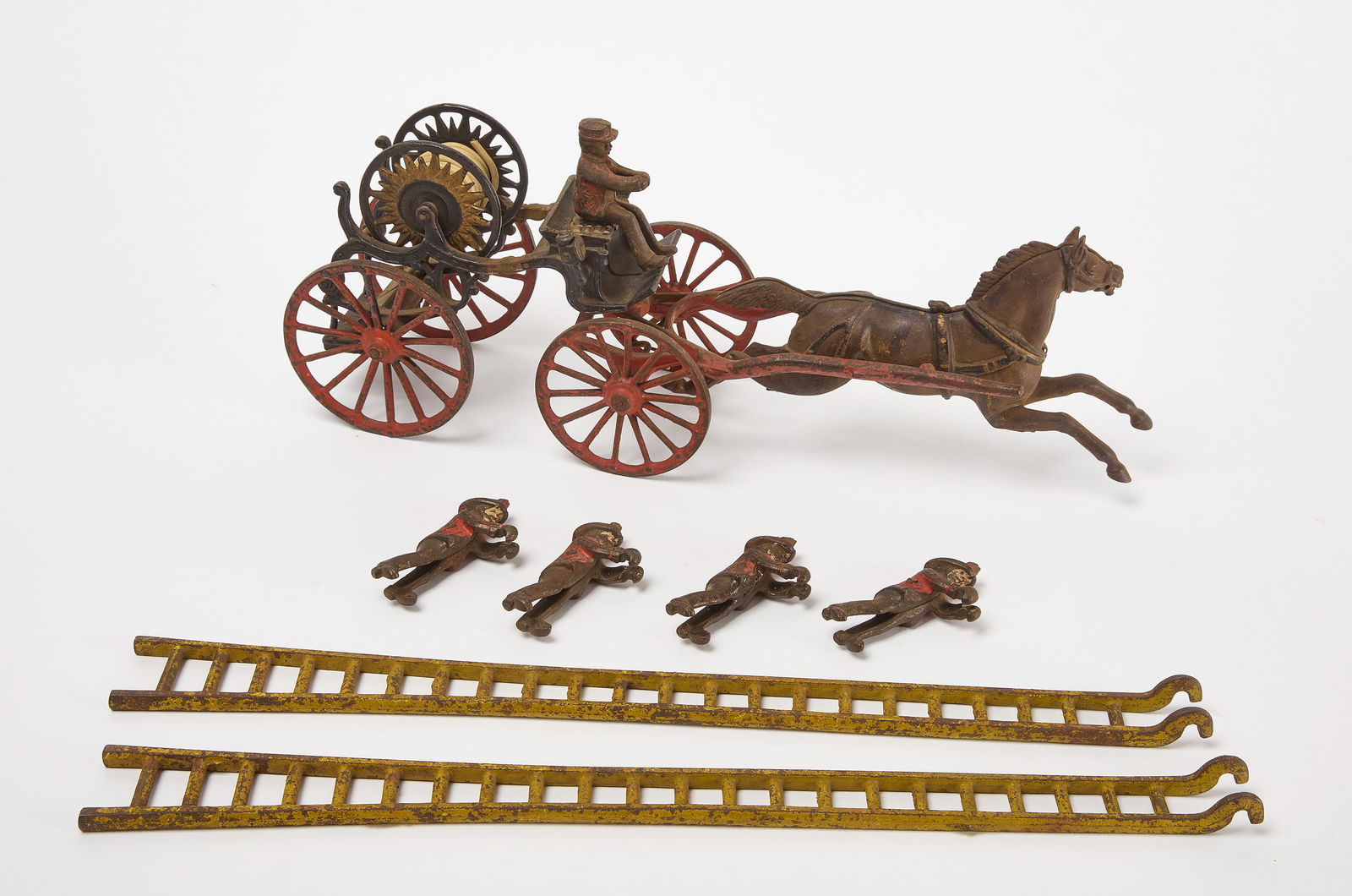 Horse Drawn Fire Patrol Toy: Horse drawn fire patrol toy. Painted cast iron figures with plastic hose. Includes two ladders and five firemen figures. Driver fireman figure can be removed from seat. Four firemen hook to hang