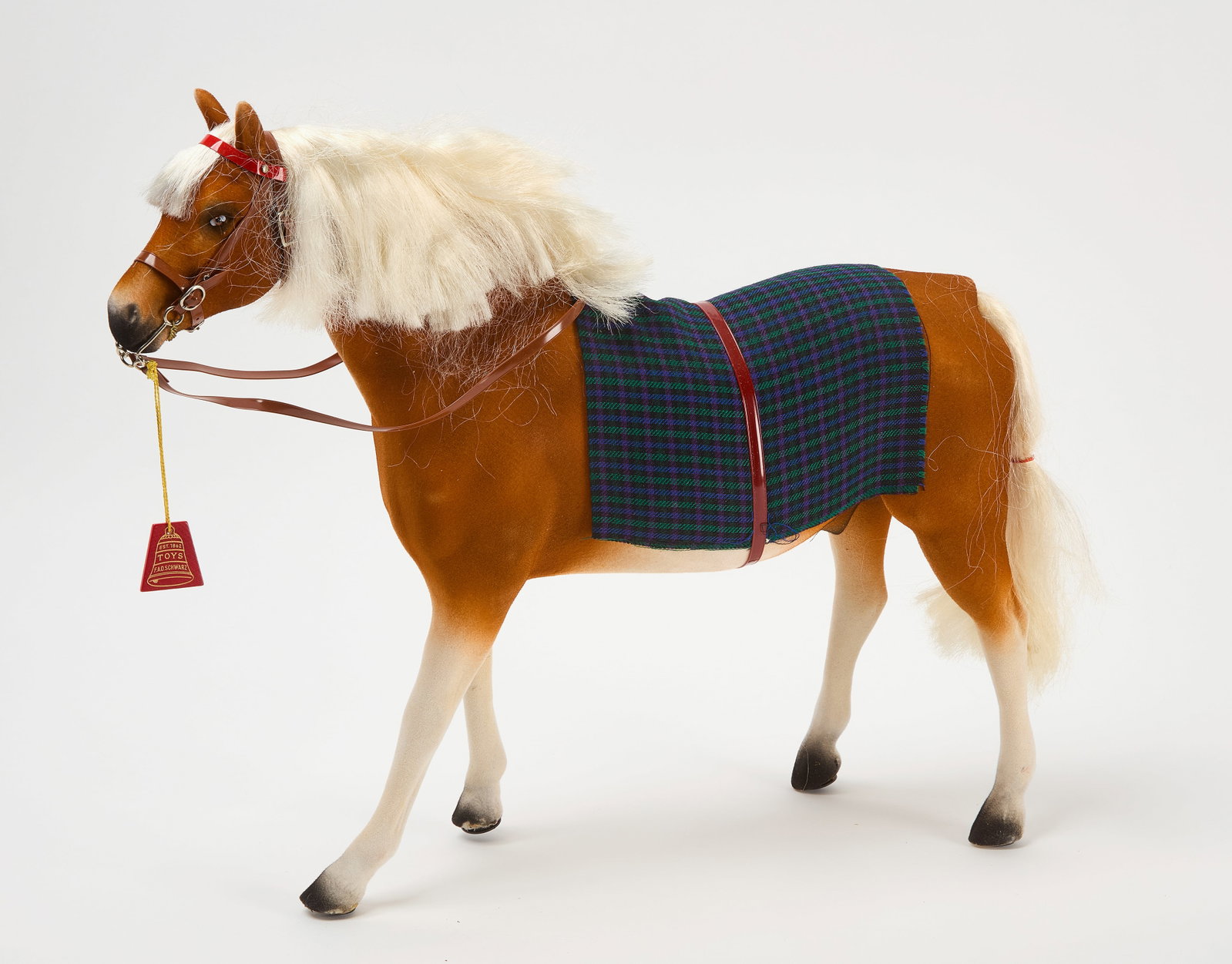 FAO Schwarz Horse Toy in Original Box: FAO Schwarz horse toy with original packaging and box. Horse: H 15-3/4 in. L 18-3/4 in. W 4 in. Box: H 6 in. W 21 in. D 17 in. Condition: Some imperfections to outer box as expected. Overall very good