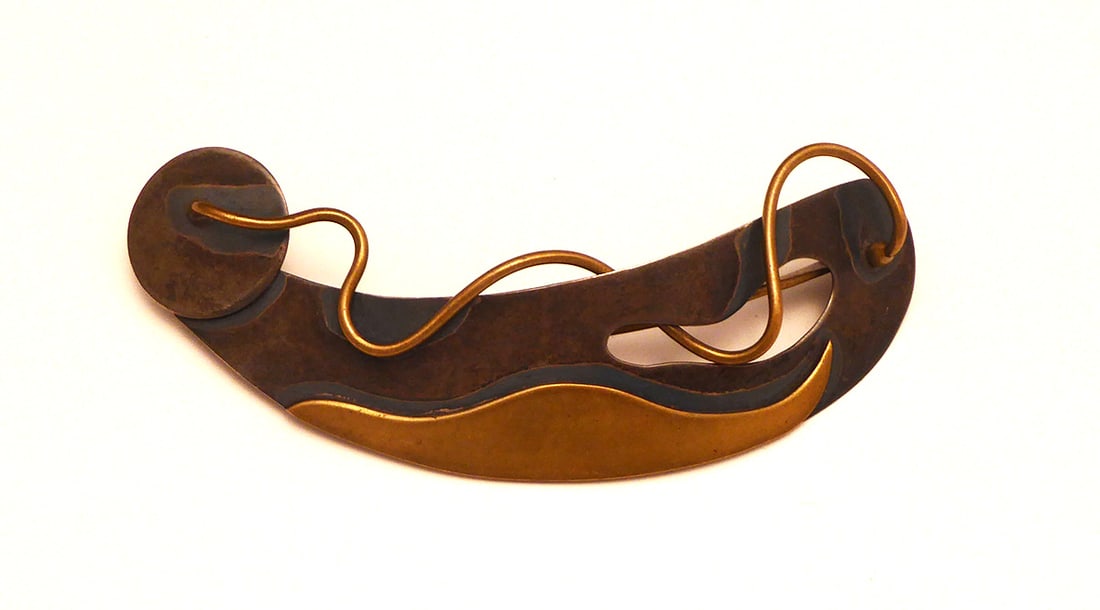 Ed Wiener Modernist Brooch: Ed Weiner modernist brooch. Sterling silver and brass. Stamped on back right corner. H 1-3/4 in. W 5 in. Condition: Minor wear from use. Pin-back is in working order. Wearable. Link t