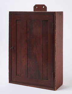 Painted Hanging Door Cupboard: Painted hanging door cupboard in old finish. Door opens to the right to reveal two inner shelves. Backside of door retains a page of 'The School District Library' published by Harper & Brothers. Ameri
