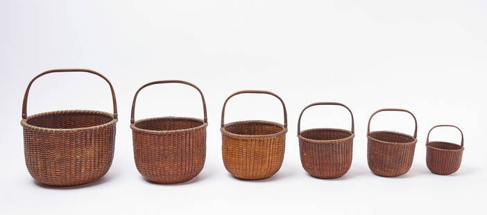 Nesting Set of Six Nantucket Swing-Handle Baskets: A nesting set consisting of 6 swing-handle baskets of varying sizes. Nantucket (Massachussetts), 19th century. century. Measurements provided exclude handles. Largest: H 8-1/4 in. D 12 in. Smallest: H