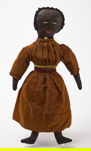 Afro-American Rag Doll in Velvet Trim Dress: Afro-American rag doll in velvet trim dress. Fabric doll and original clothing. Wearing dress with velvet trim and buttons, rosette ribbon necklace, as well as a full underdress, underskirt, and bloom