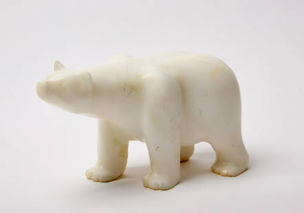 Inuit Carved Stone Polar Bear: Inuit carved stone polar bear. Alaska, 20th century. H 5-1/2 in. L 10-1/2 in. W 4 in. Condition: Minor surface imperfections and light scratches. Link to high-res images: https://www.dropbo
