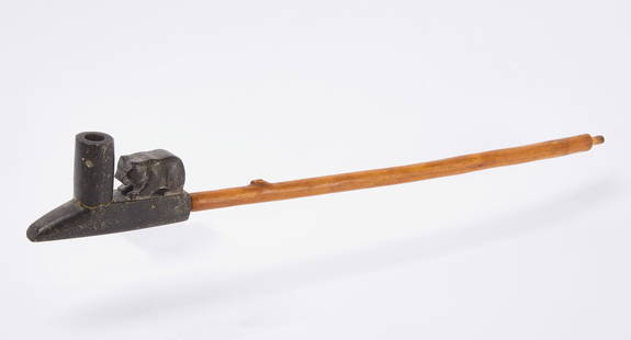 Native American Stone Pipe: Native American carved stone pipe with bear. North America, 19th century. Pipe: L 5-1/4 in. Overall with stem: L 24-3/4 in. Condition: Pipe bowl cracked and glued. Pipe stem of a later date. Link to h