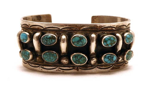 Navajo Silver and Turquoise Cuff Bracelet: Navajo vintage hammered silver and multiple turquoise stones. Stamped 'TT' (Tommy Tso). Southwestern U.S., 20th century. H 12-1/8 in. W 2-1/2 in. D 2 in. Inner width: 2-1