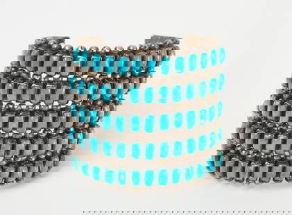 Navajo 5-Band Silver and Turquoise Cuff, Signed 'EA': A Native Navajo silver cuff with 5 bands of turquoise stones, signed with initials 'EA'. American, circa 1940. H 2-1/2 in. W 2-1/2 in. D 2-1/4 in. Inner width: 2-1/4 in. Inner depth: 2 in