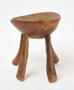 African Four-Legged Carved Stool: African four-legged stool. Carved wood. African. H 11-1/2 in. D 9-3/4 in. Condition: Several old splits descending from the top rim; not atypical for a piece like this. Sturdy and without repair