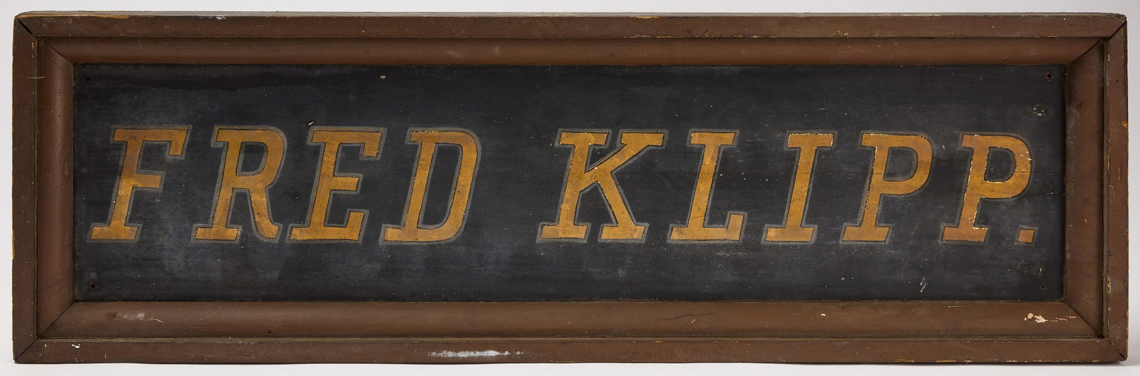 Fred Klipp Trade Sign: Fred Klipp trade sign. Gilt paint on wood, in wood frame. American, early 20th century. H 14-1/2 in. W 46-1/2 in. Condition: Original condition with minor imperfections.