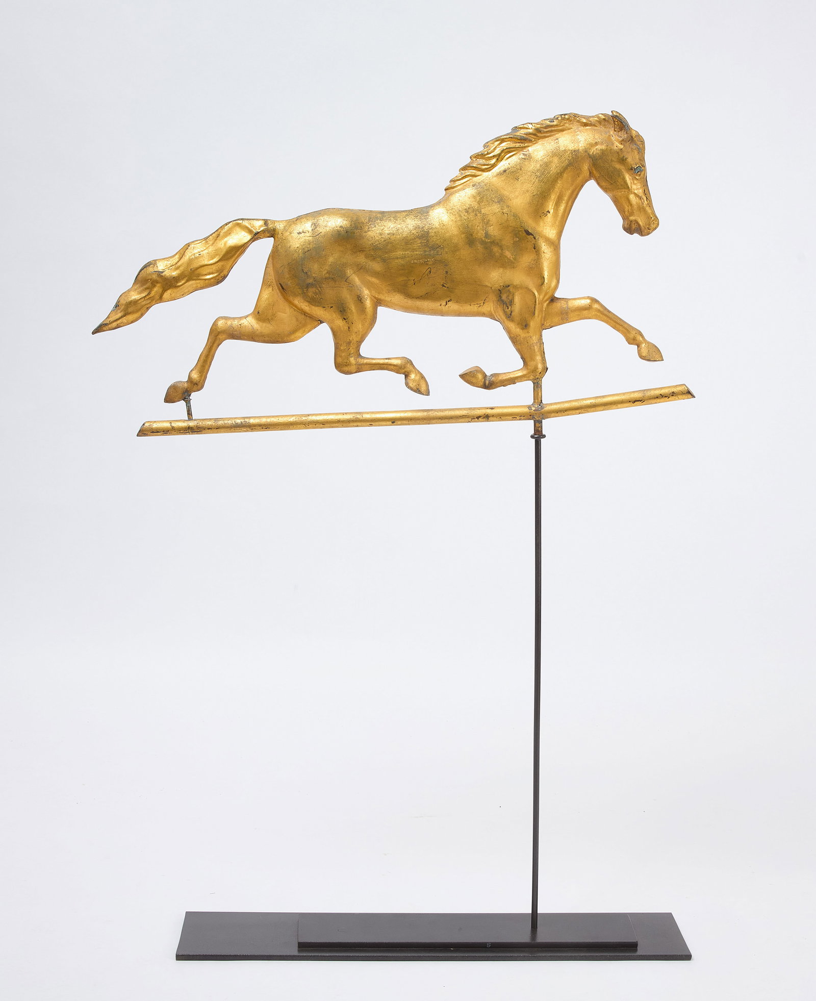 J. Harris & Son Horse Weathervane: Galloping horse weathervane stamped J. Harris & Son, Boston. Full-bodied hollow molded copper with much of the gilt surface intact. American, circa 1870. H (on stand) 48-3/4 in. (Horse only): H 18