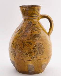 Ovoid Redware Pitcher with Incised Decoration: Ovoid handled redware pitcher. Incised floral decoration. American, 19th century. H 11-1/4 in.Condition: Losses, rim chips, and tightly-crackled glaze. Link to high-res images: