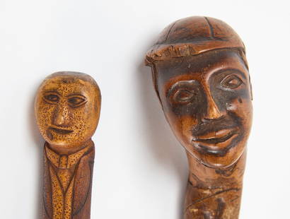 Two Carved Folk Art Walking Sticks: Two carved&nbsp;walking sticks. One of a man with carved suit. The second of a Afro-American man with baseball cap. L 36 in. L 36-1/2 in. Condition: No damage noted. Minor imperfections and wear from