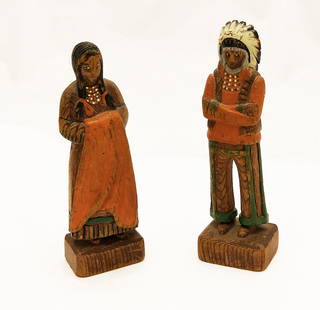 Two Carved and Painted Native American Figures: Two Native American figures; a Chief with headdress and a squaw. Carved and painted wood. American, circa 1920. H 6-7/8 in. H 6-1/2 in. Condition: Surface wear and losses noted.