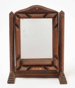 Tramp Art Vanity Mirror: Tramp art chip-carved vanity mirror on swivel stand. Small carved heart on top middle. American, early 20th century. H 16 in. W 12-1/2 in. D 7-1/2 in. Condition: Minor surface imperfections.&nbsp; Lin
