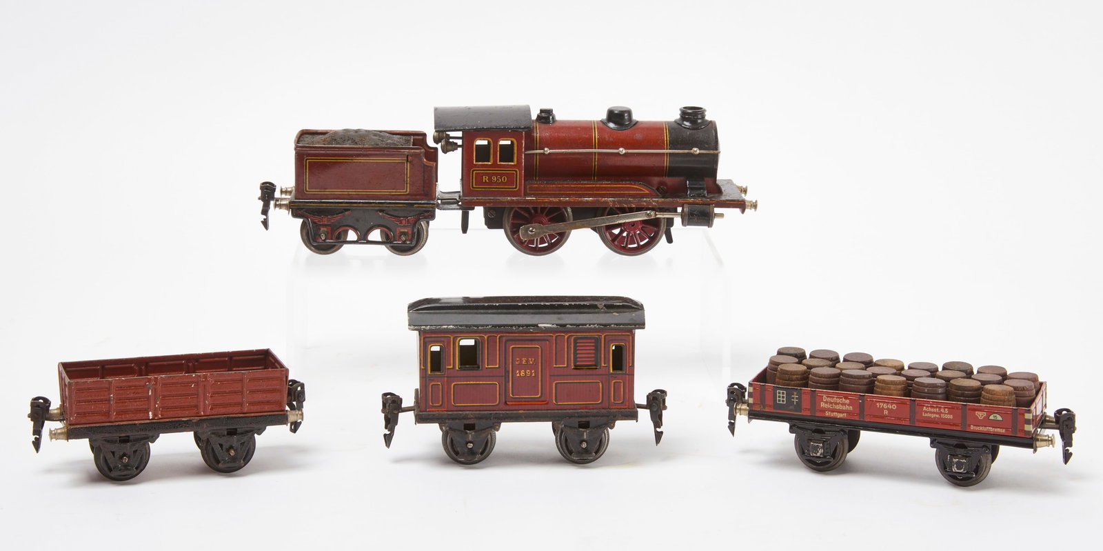 Marklin R950 Locomotive with Cars: Marklin R950 locomotive in red with coal tender, oil car, barrel car, and a covered car. Germany, early 20th century. Locomotive only: L 7-1/2 in. Overall (approx): L 28-1/2 in. Condition: Untested; m